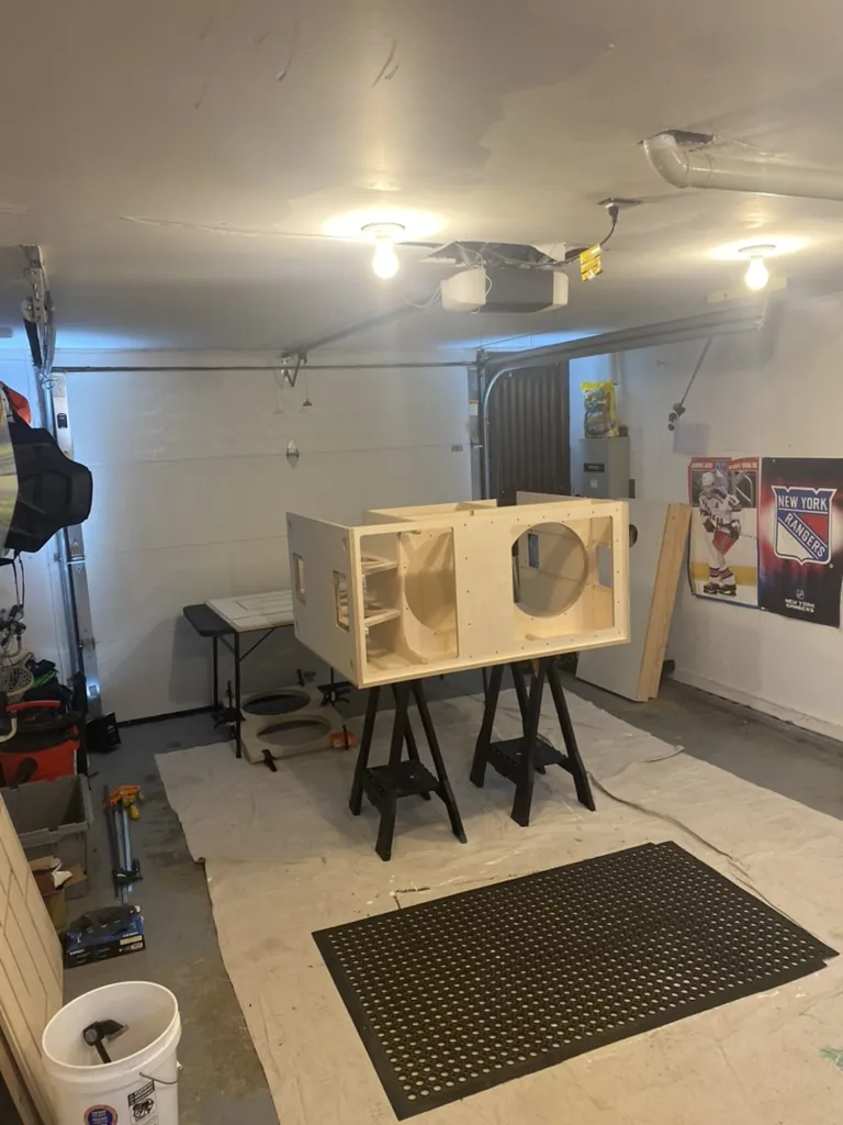 A raw cabinet on sawhorses in the garage