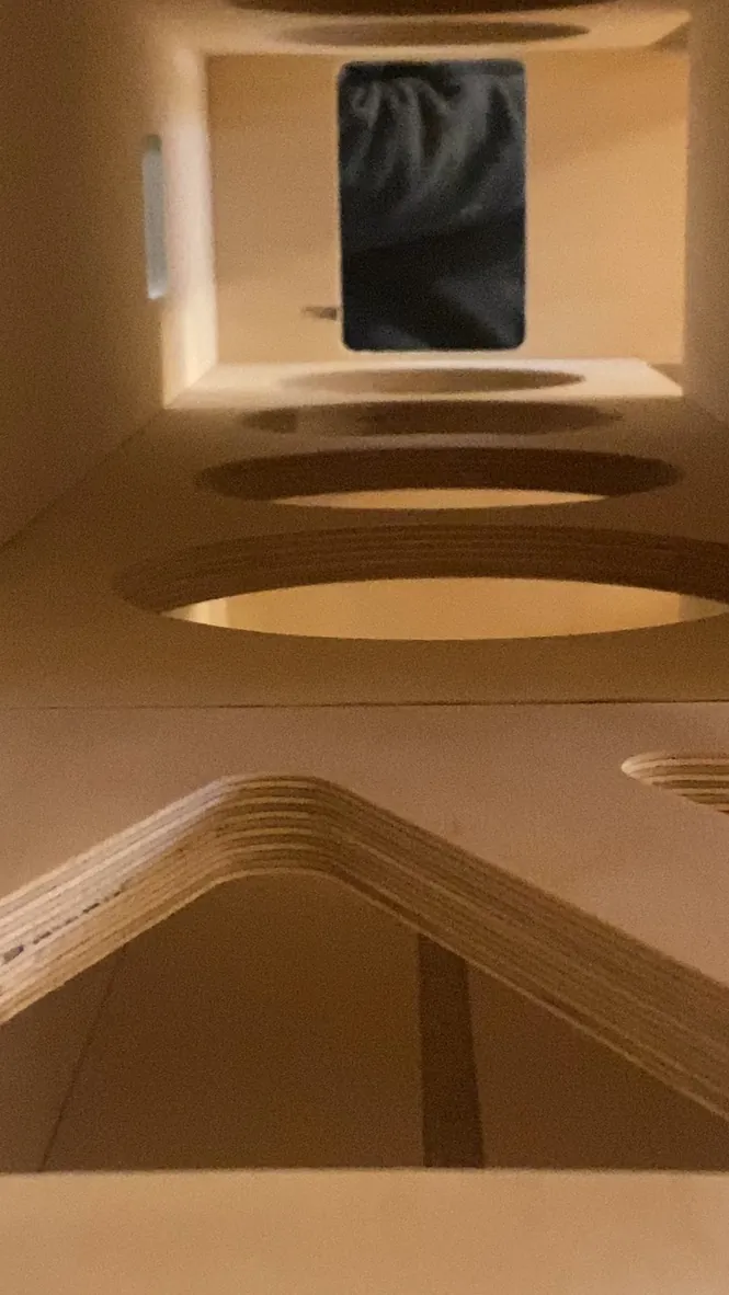 View down the inside of a cabinet showing layered plywood braces