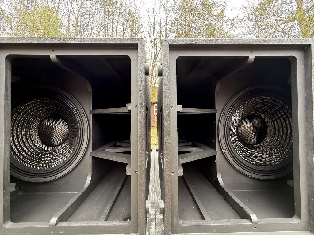 Two black subwoofers side by side with their drivers visible